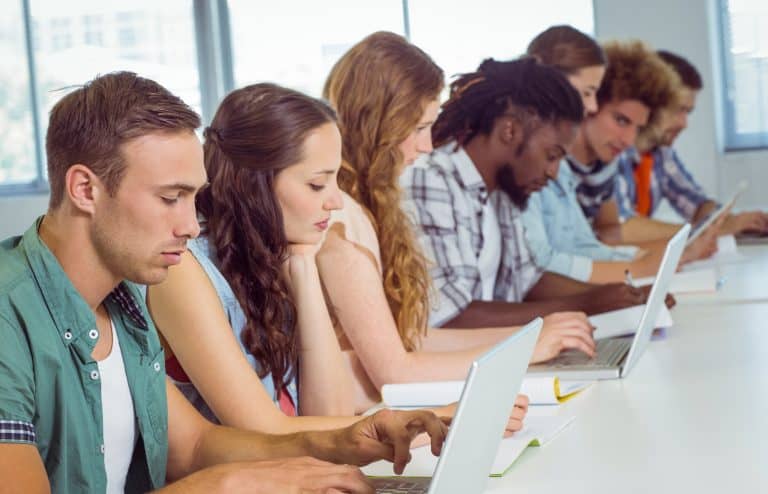 Fashion students using laptop at the college