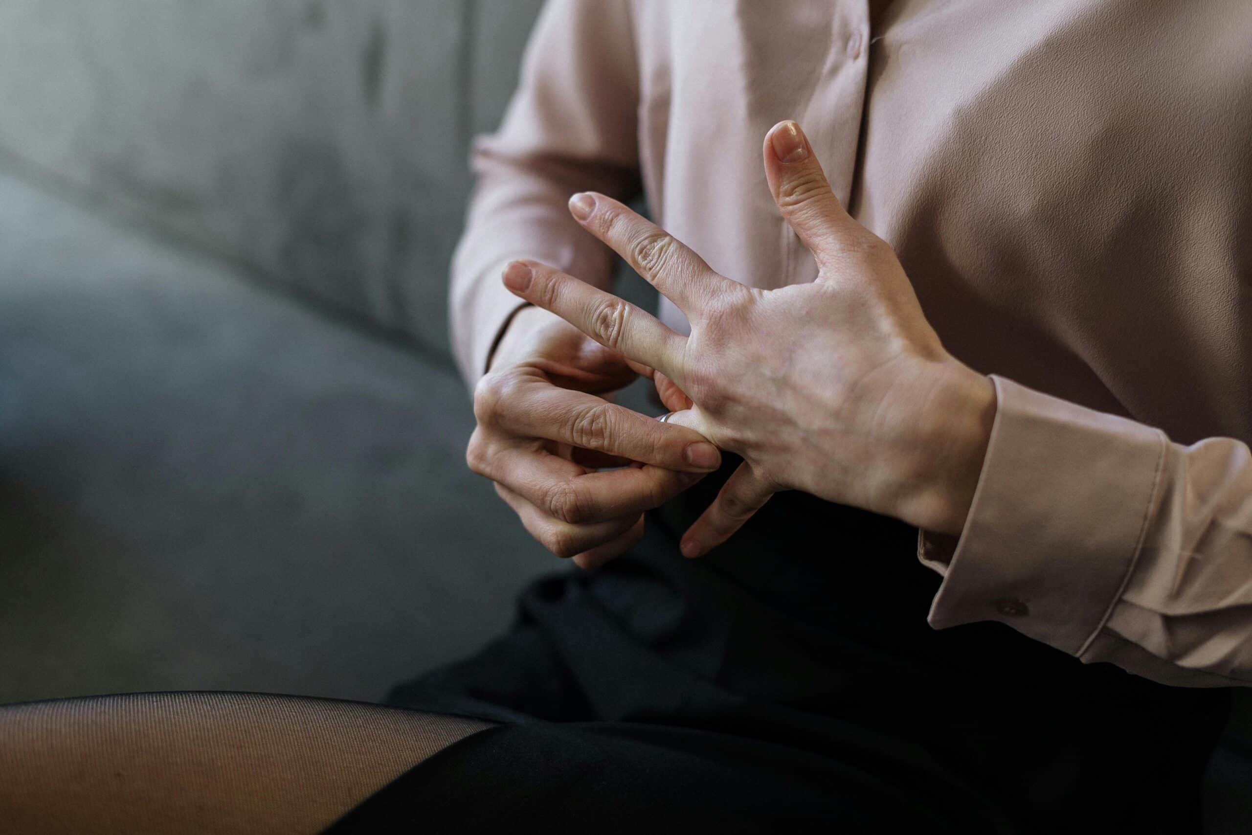 Woman taking off her wedding ring - Starting Over After Divorce